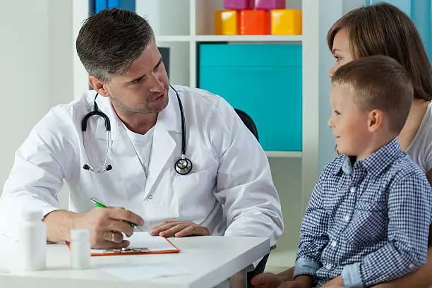 Doctor consulting with a child at Opal Hospital