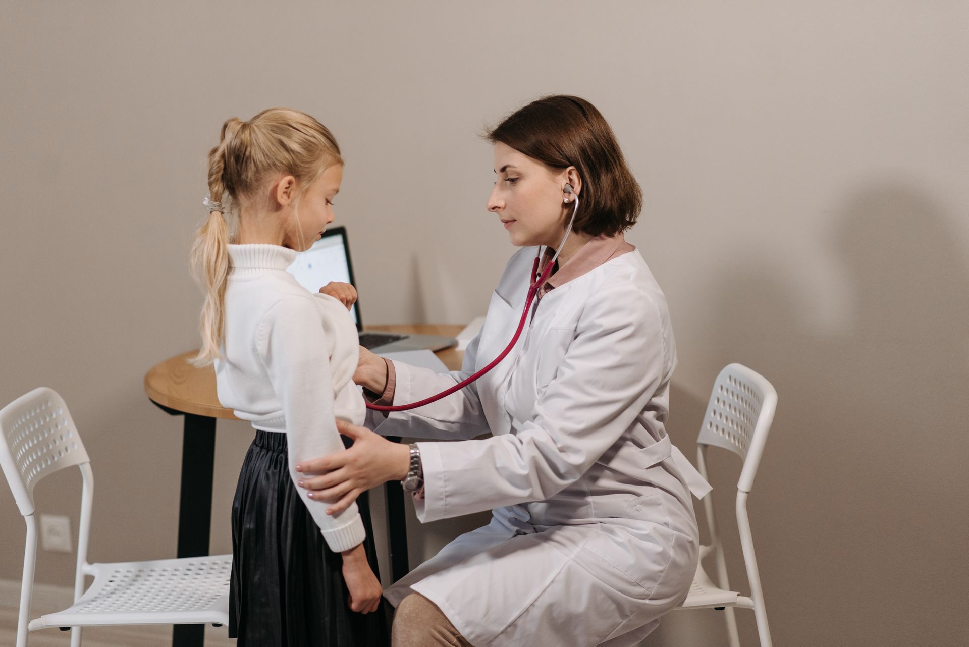 Pediatrician examining a child at Opal Hospital